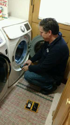 AmTech technician working on an appliance
